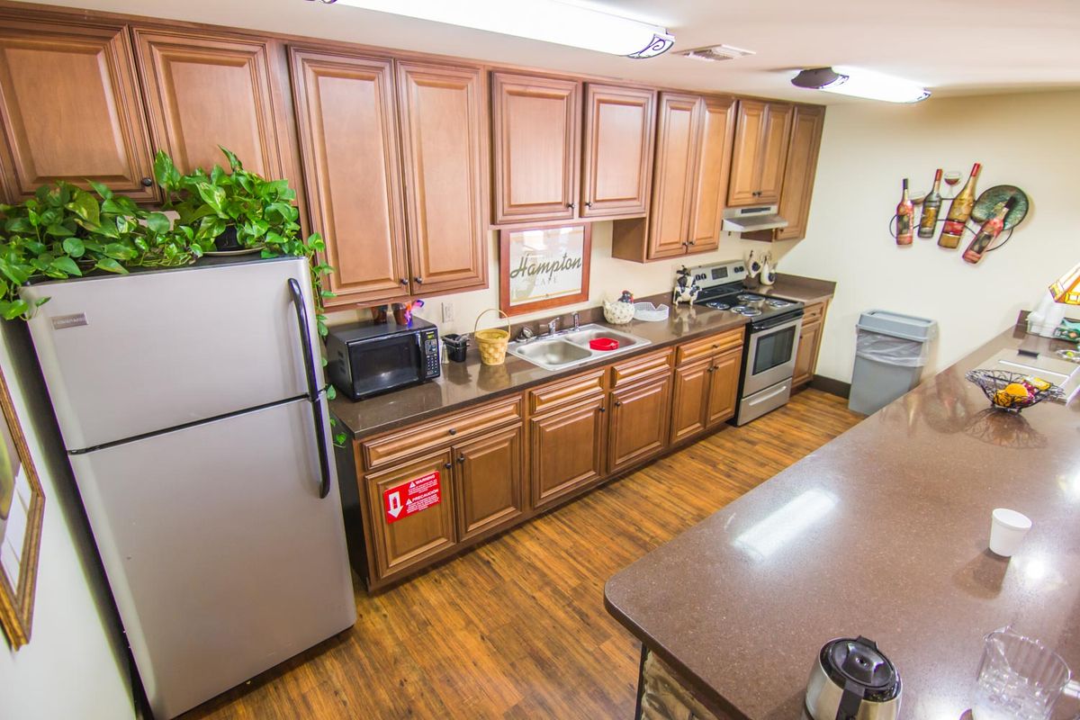 A modern kitchen with wooden cabinets and stainless steel appliances.