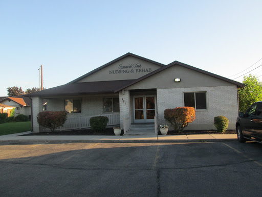 A serene view of a building at sunset, showcasing minimal landscaping and an inviting entrance.