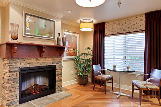 A cozy living room featuring a warm fireplace, comfortable seating, and stylish decor.