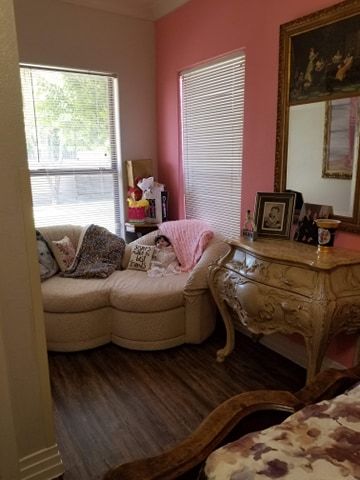 A cozy living room corner with a sofa, dresser, and mirror.