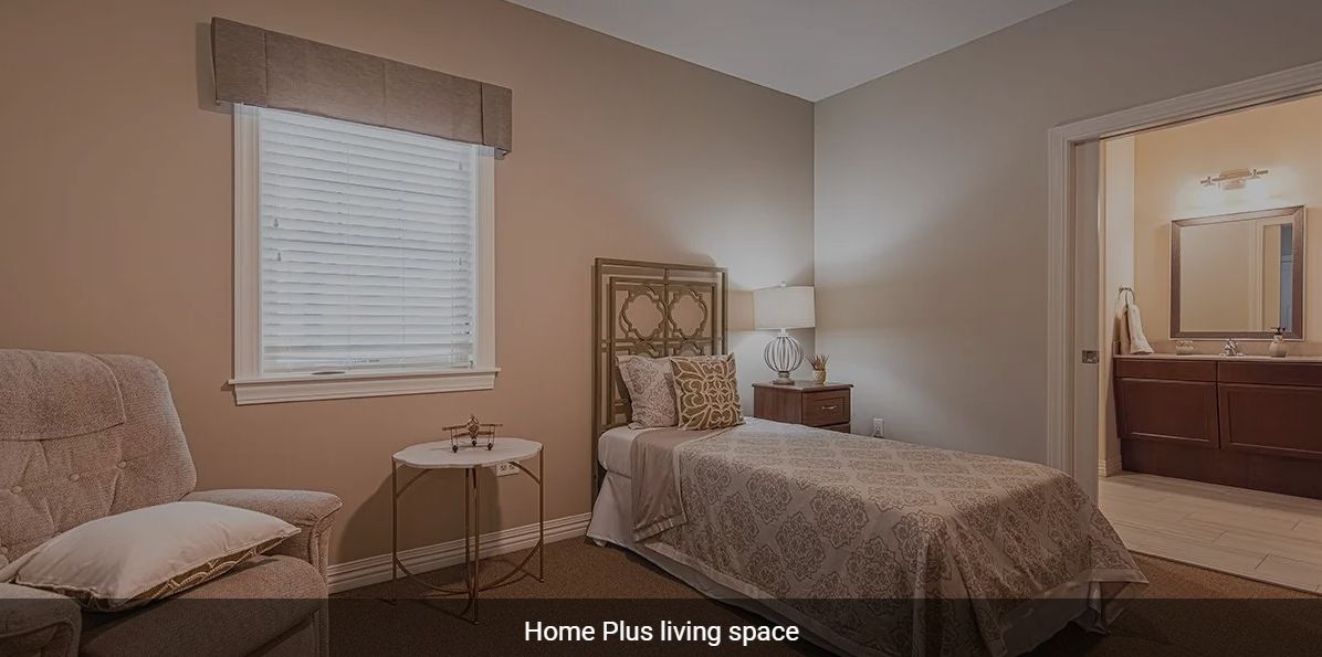 A cozy bedroom with a single bed, nightstand, and lamp.