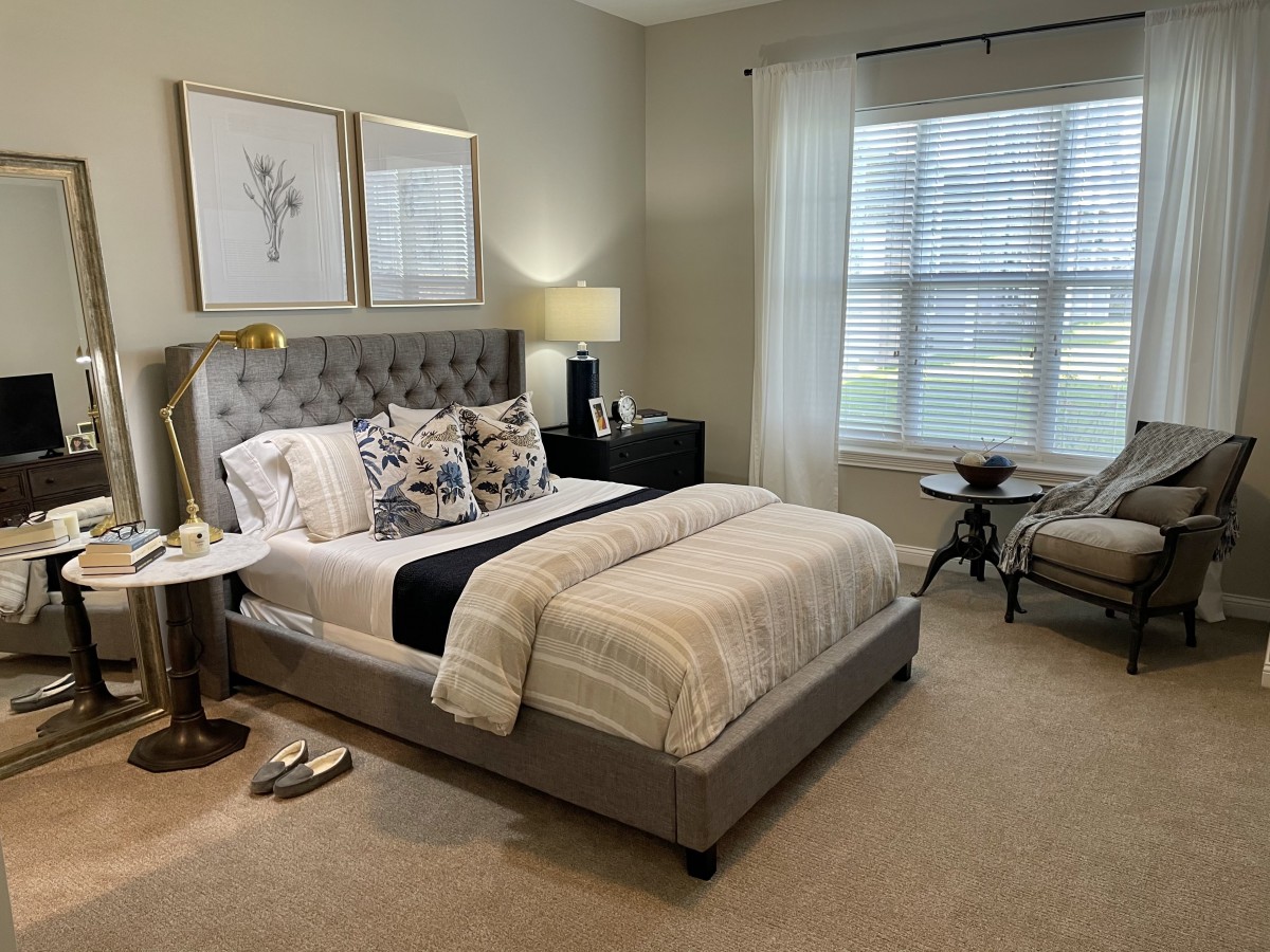 A beautifully decorated bedroom with a stylish bed, elegant furniture, and calming neutral tones.