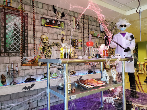 A whimsical Halloween-themed laboratory featuring skeletons and other eerie decorations, perfect for a mad scientist vibe.