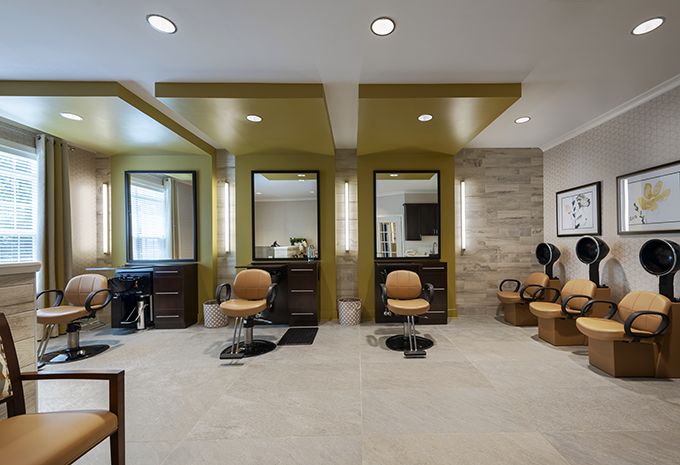A modern salon interior featuring styling chairs and mirrors.
