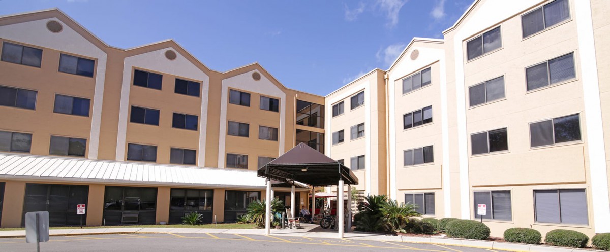 A modern hotel building with multiple stories and a covered entrance.