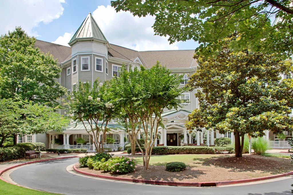 A picturesque building surrounded by lush trees and greenery.