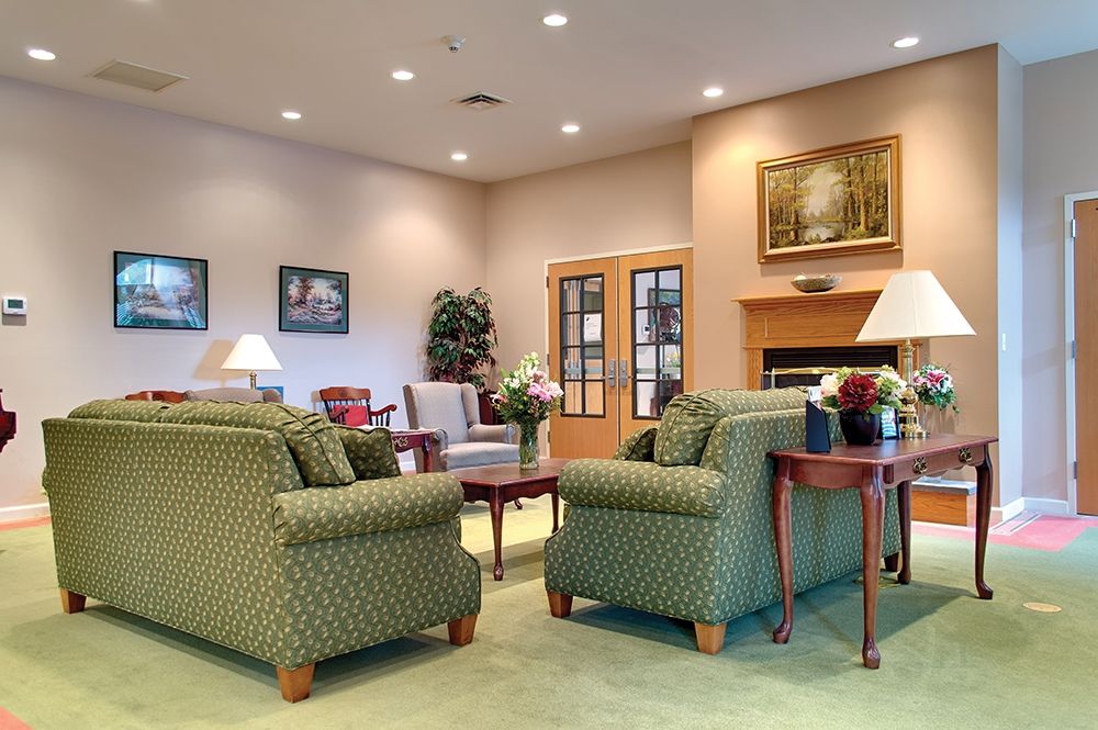 A cozy living room with comfortable seating arrangements and a fireplace.