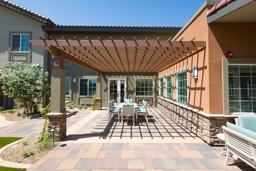 A beautifully designed outdoor patio with a pergola, ideal for relaxation and gatherings on sunny days.