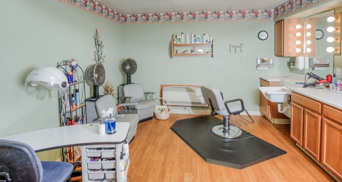 A quaint hair salon interior with styling chairs and beauty equipment.
