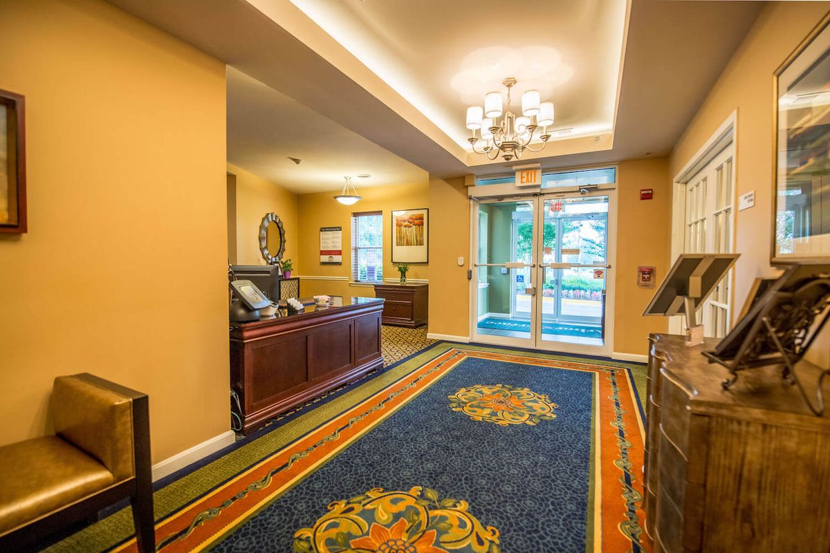 A welcoming hotel lobby with elegant decor and a chandelier.