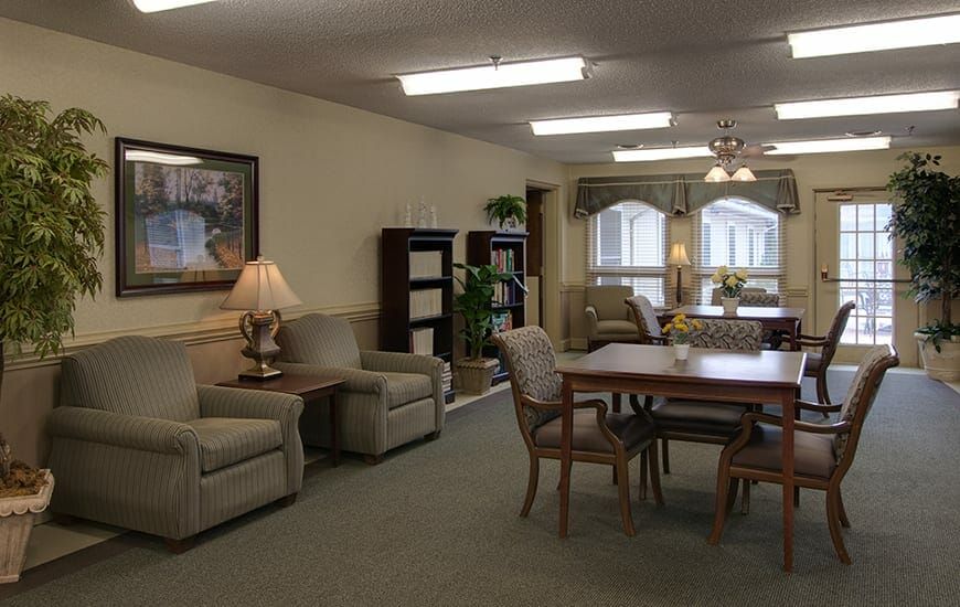 A cozy living room area featuring comfortable seating and a wooden dining table.