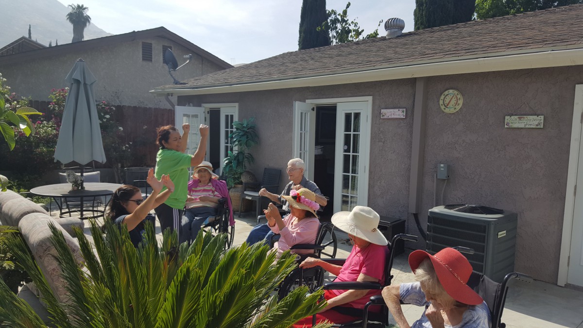 A group of seniors enjoying a sunny day outdoors with activities.