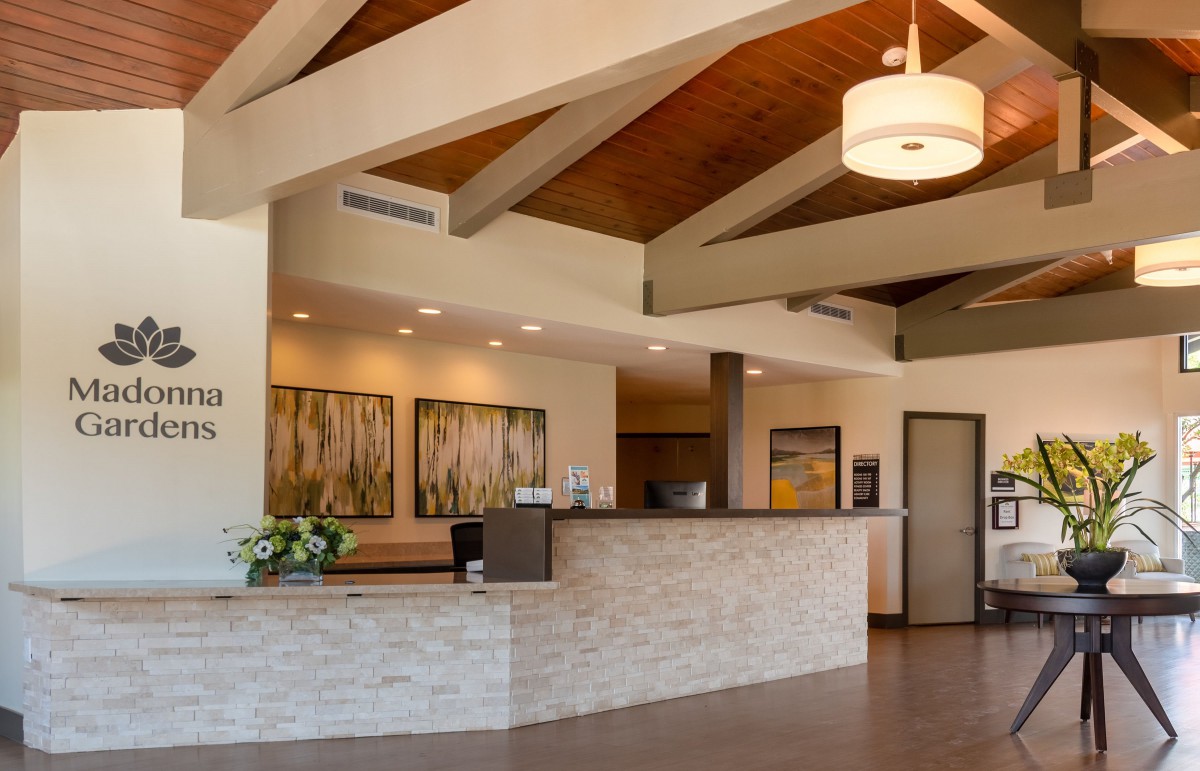 A modern reception area with decorative lighting and ceiling beams.