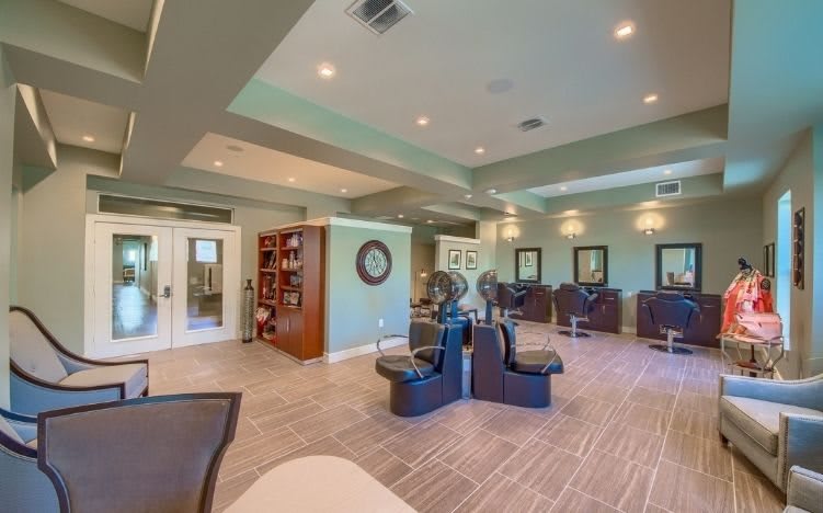 A modern salon interior with stylish chairs and mirrors.