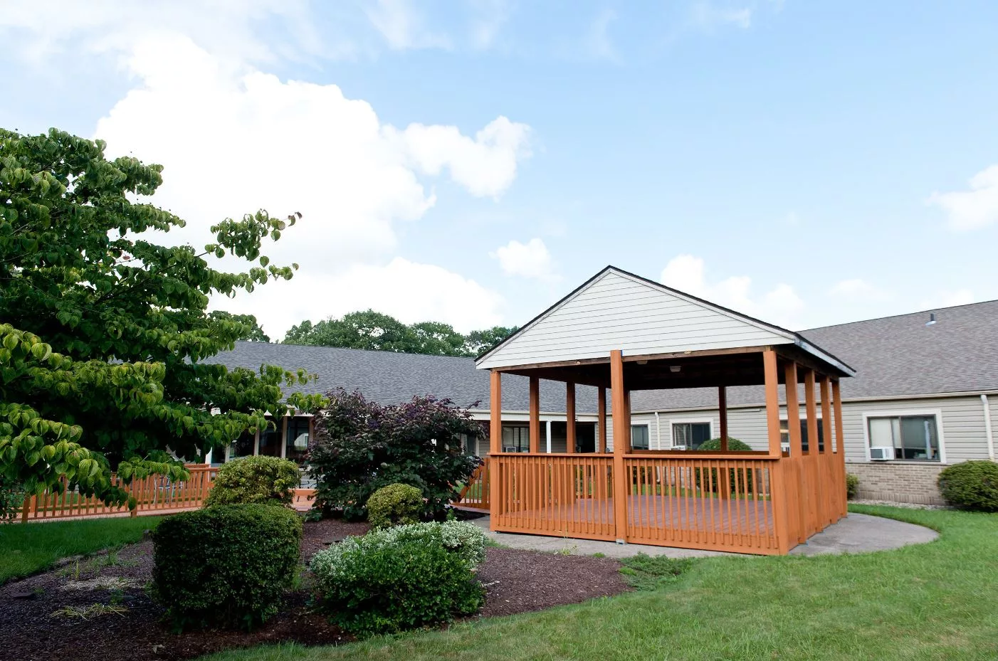 A scenic outdoor setting with a wooden gazebo and surrounding greenery.