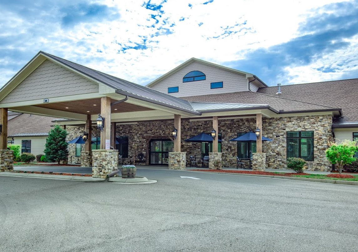 A hotel entrance with a stone facade and peaked roof.
