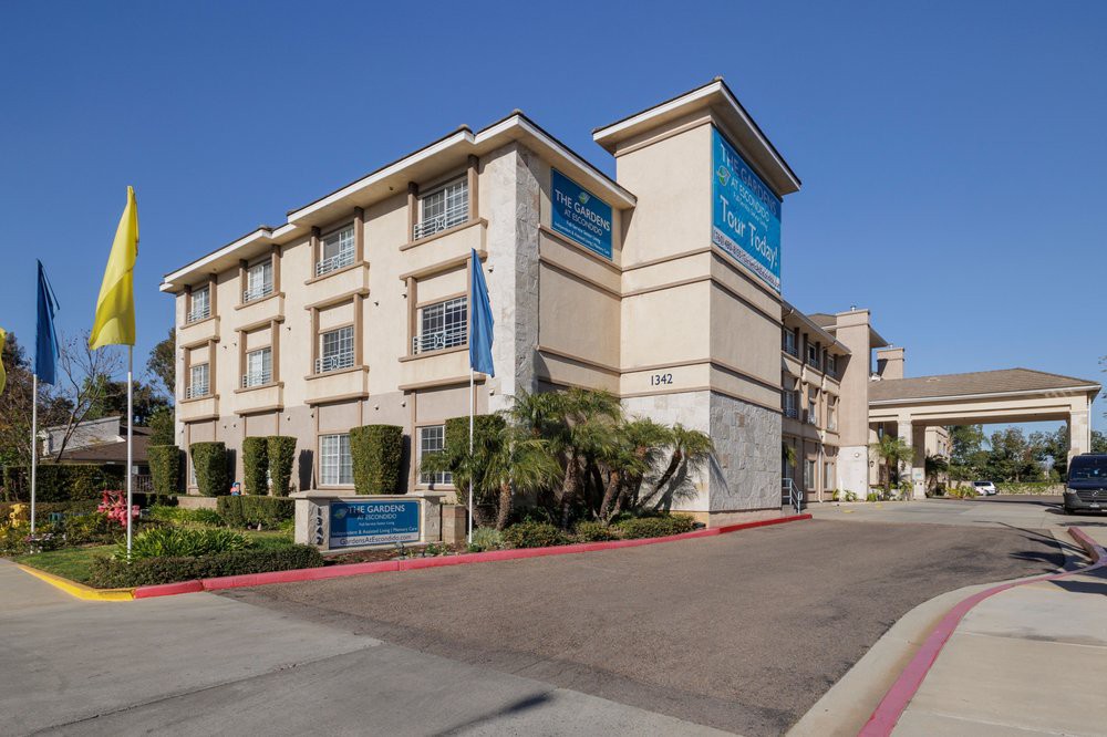 A modern hotel building with clear blue signage and landscaping.