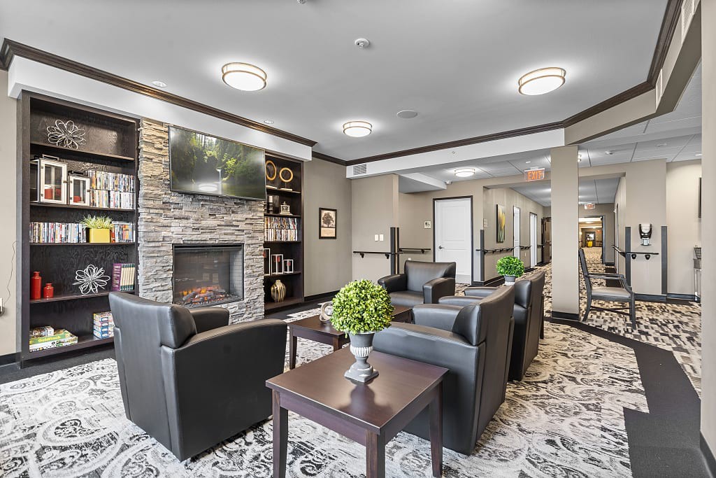 A modern lobby with a cozy seating area featuring a fireplace and stylish decor.