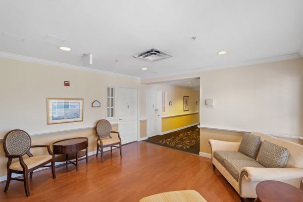 A cozy waiting room with seating and a hallway entrance.