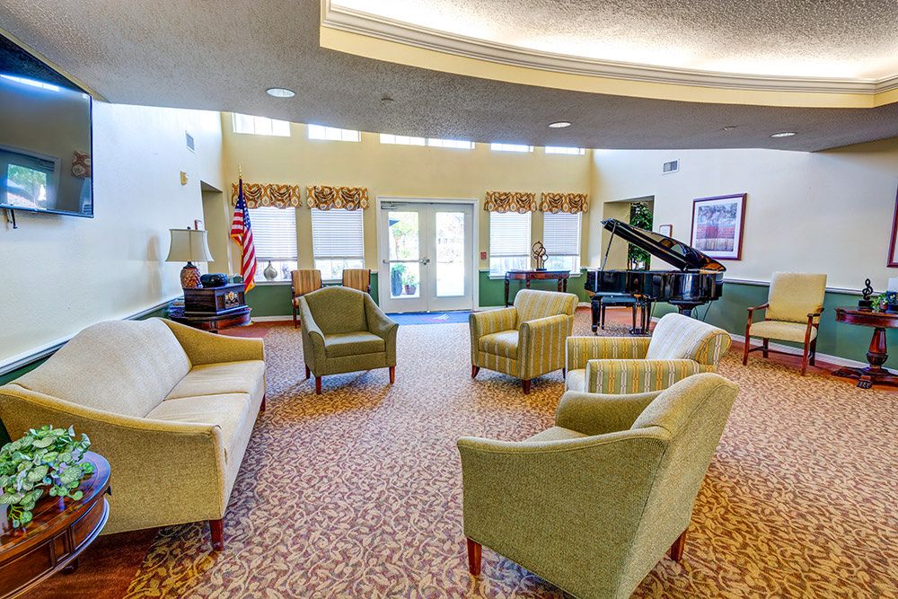 A spacious lobby with comfortable seating and a grand piano.