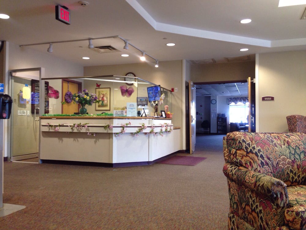 A view of a reception area in a lobby with seating and decor.