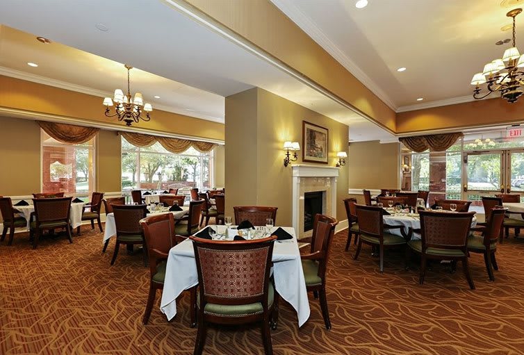 An elegant dining area with neatly arranged tables and a warm ambiance.