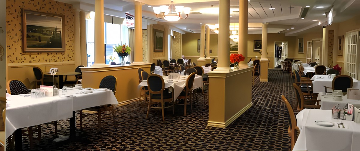 An elegant restaurant interior with neatly arranged tables and chairs.