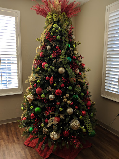 A beautifully decorated Christmas tree adorned with colorful ornaments and ribbons, bringing holiday cheer to the room.
