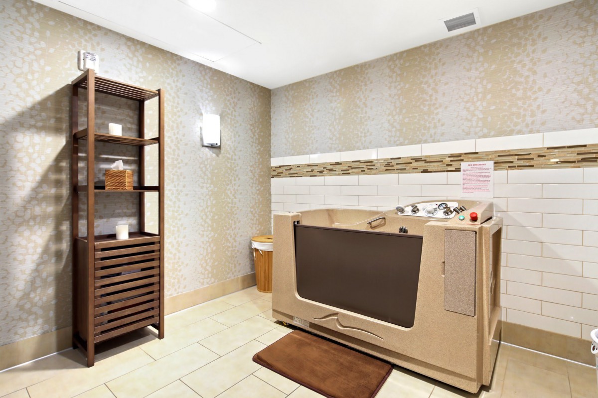 A serene spa room with a specialized bathtub for relaxation.