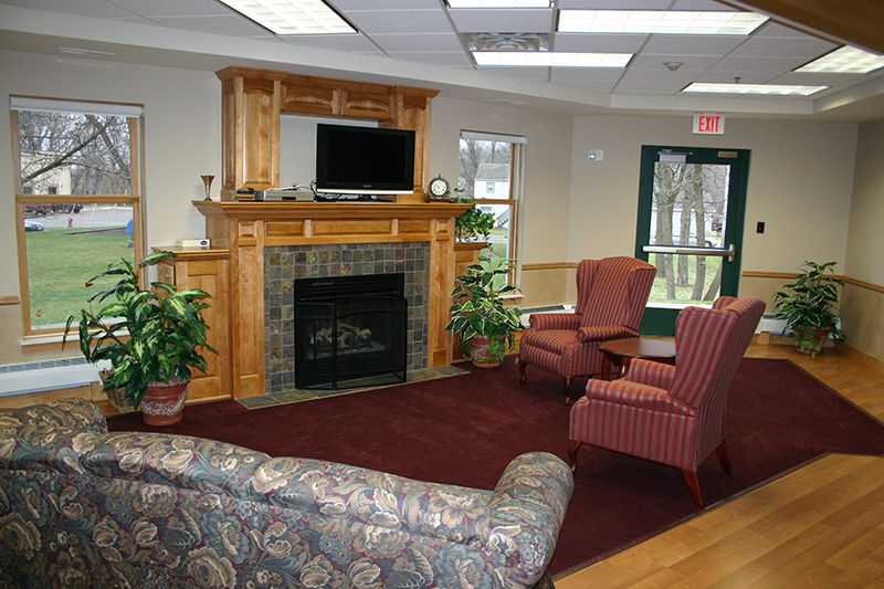 Cozy living room with a fireplace, television, and comfortable seating.