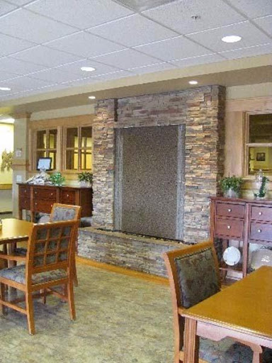 A cozy lobby area featuring a stone fireplace and wooden furniture, perfect for relaxation.
