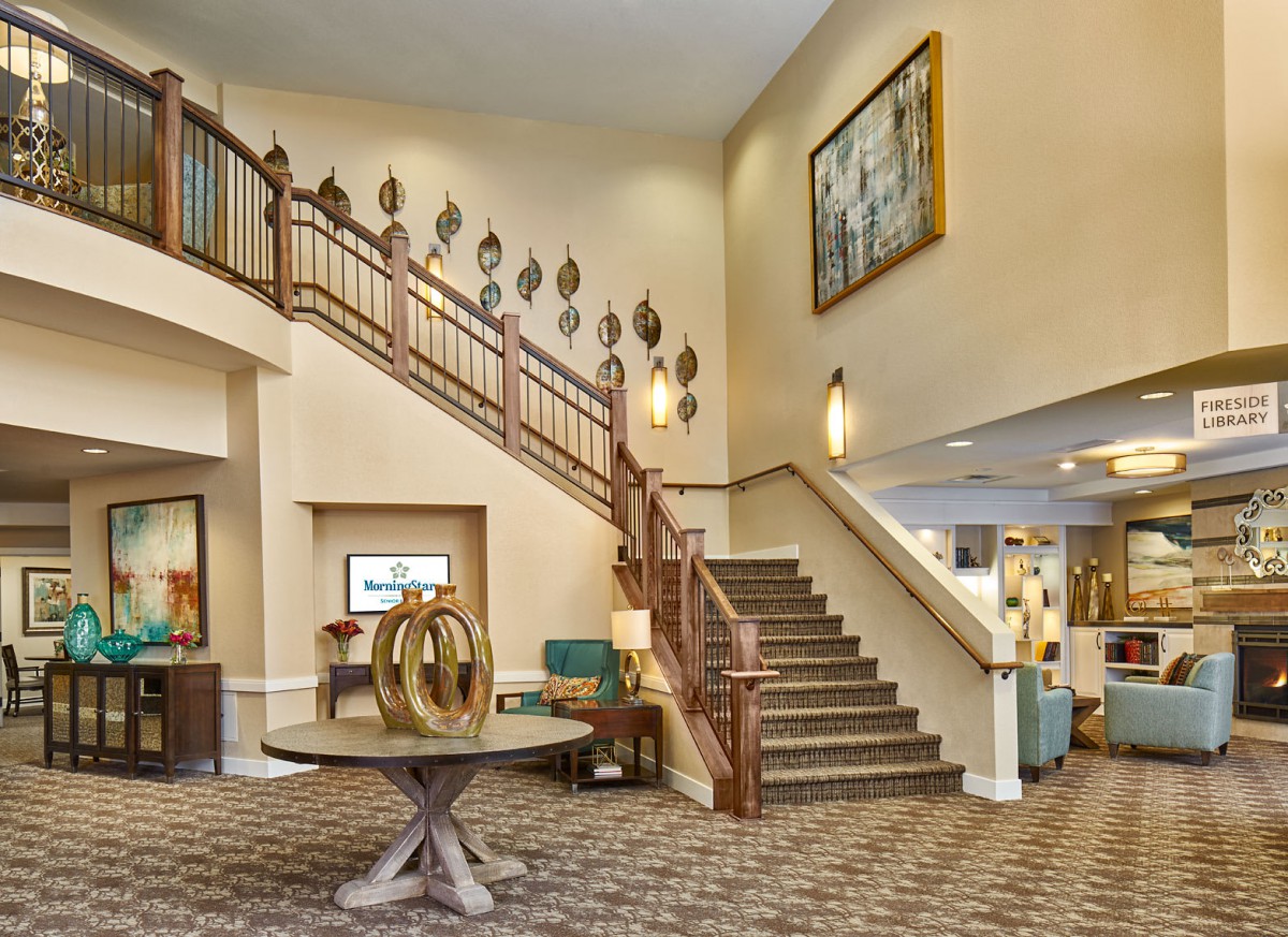 A modern hotel lobby with a staircase and stylish decor.