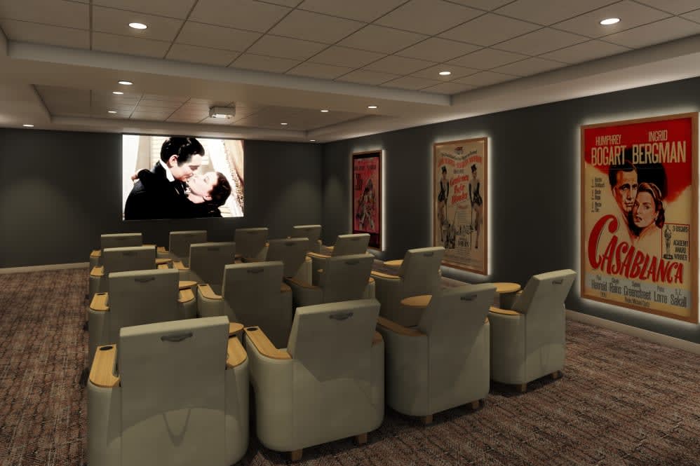 A cozy home theater with comfortable seating and movie posters on the walls.