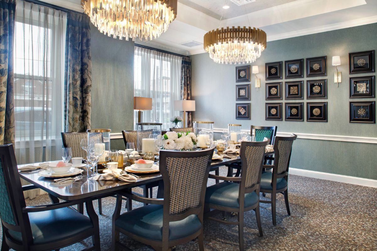 A luxurious dining room with elegant chandeliers and a beautifully set table.