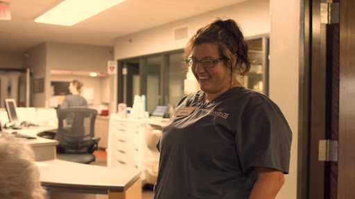 A healthcare worker shares a joyful moment in a hospital setting.