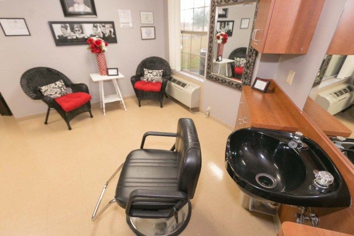 A cozy salon interior with a haircut station and waiting area.