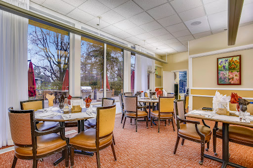 A well-lit dining area featuring tables and chairs, perfect for a restaurant setting.