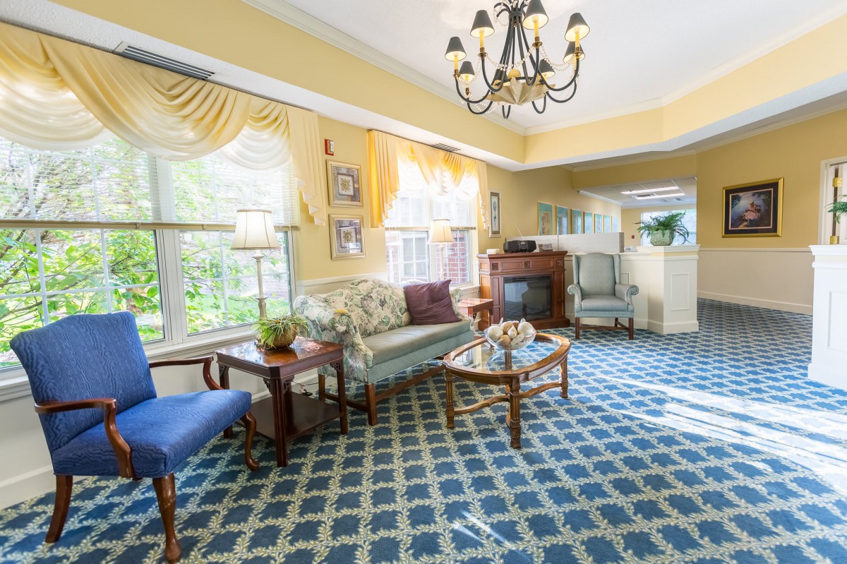 A bright and cozy living room with elegant furnishings and a patterned carpet.