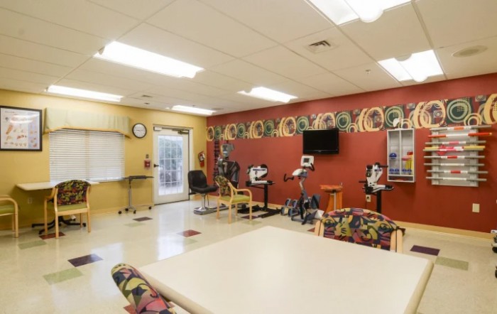 A well-lit classroom equipped with stationary bicycles and colorful decor.