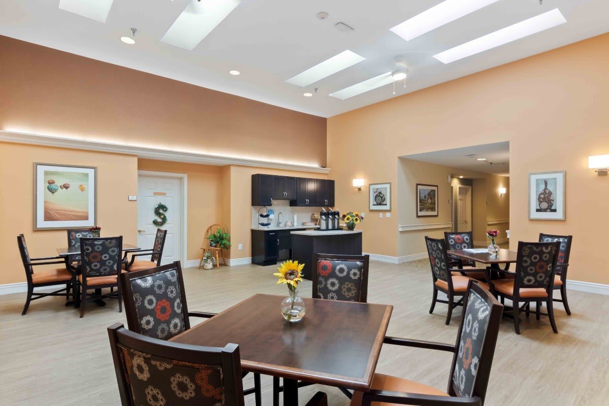 A modern dining area featuring neatly arranged tables and chairs with elegant interior decor.
