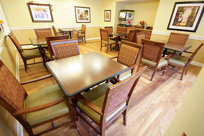 An empty dining area with neatly arranged tables and chairs, ready for guests.