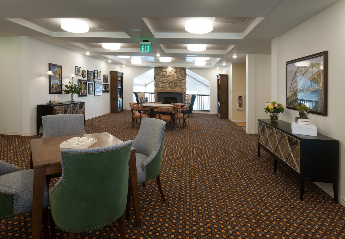 A cozy lounge area with comfortable seating and a fireplace.