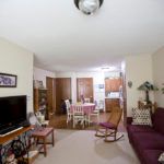 A cozy living room with a dining area, TV, and comfortable furniture.