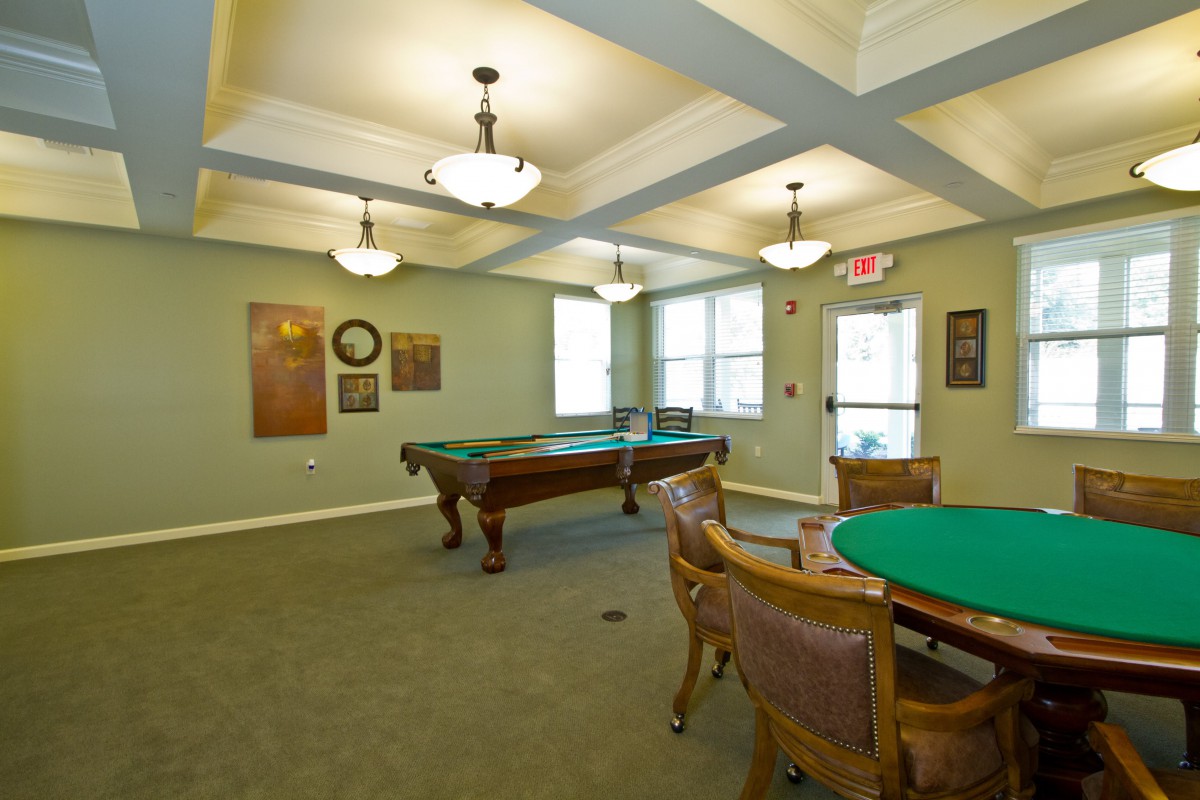 A recreational game room featuring a pool table and seating area.