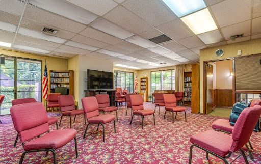 A cozy interior room featuring arranged chairs, suitable for meetings or gatherings.