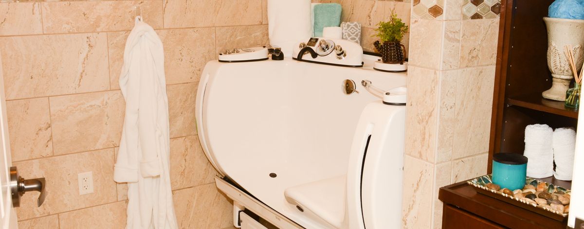 A white walk-in bathtub designed for accessibility in a modern bathroom setting.