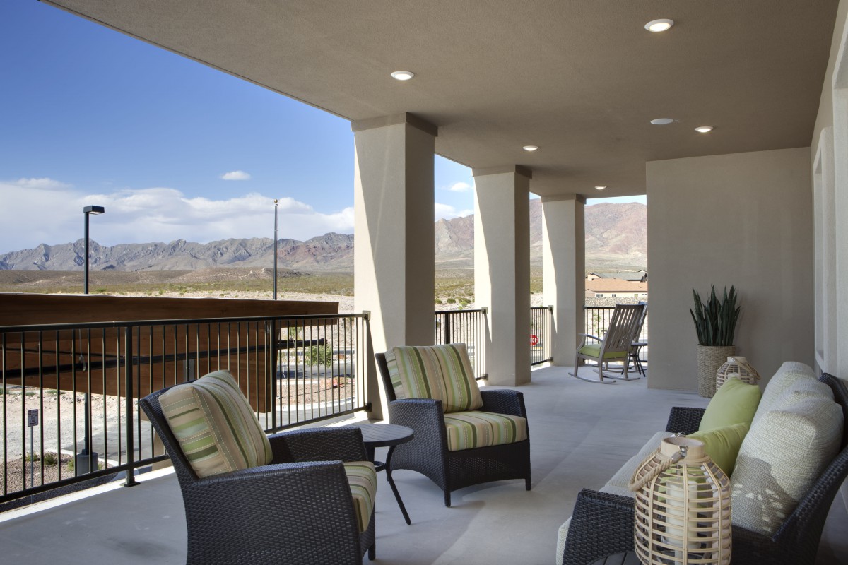 A spacious patio with comfortable seating and a scenic mountain view.