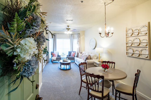 A bright and inviting living space featuring a dining area and comfortable seating arrangements.