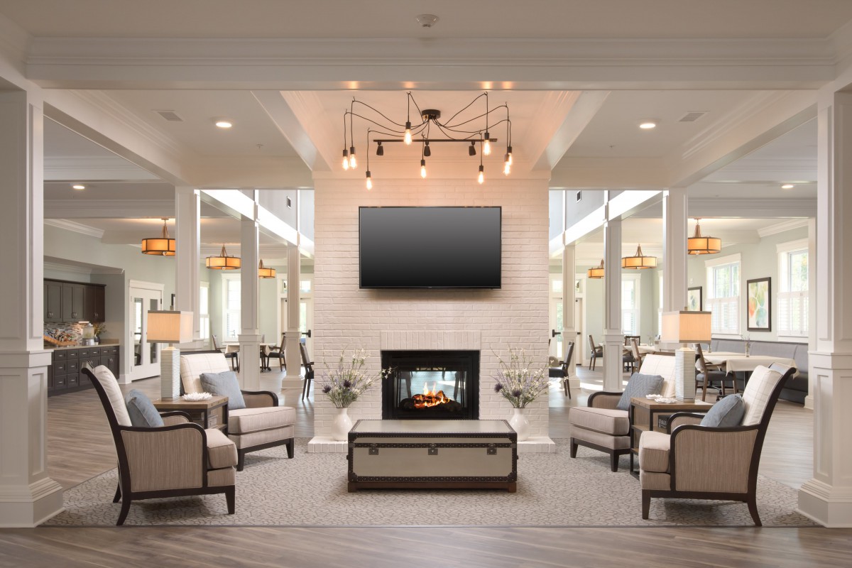 A modern living room with a central fireplace and stylish decor.