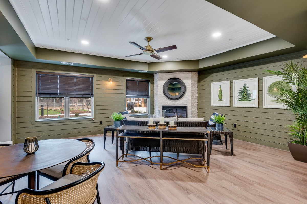 A modern living room featuring a central fireplace, stylish furniture, and elegant decor.